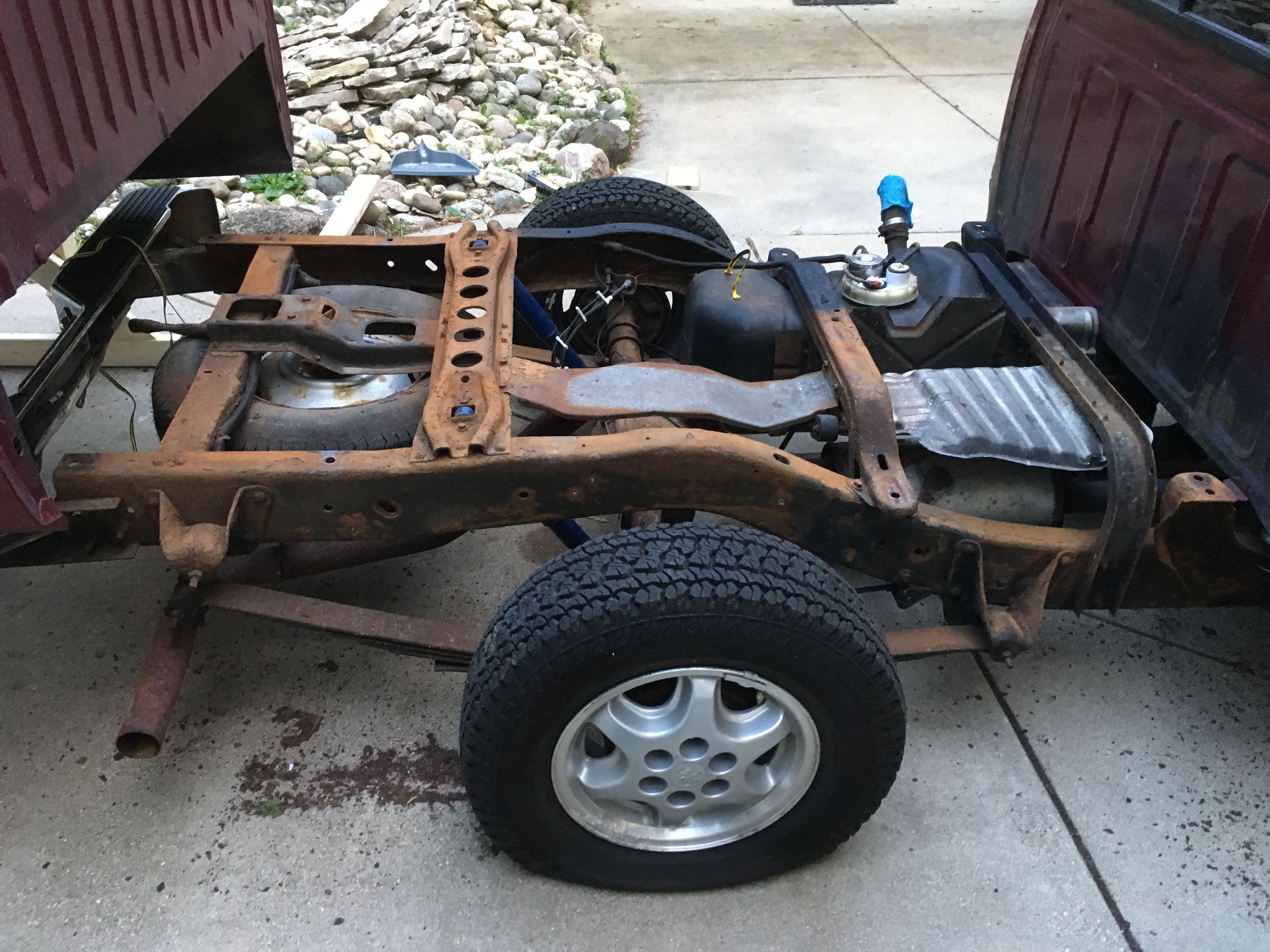 Removing the bed for gas tank strap replacement 