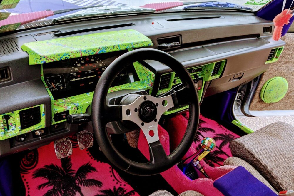 Neon 90s theme Dodge Ram 50 pickup truck interior