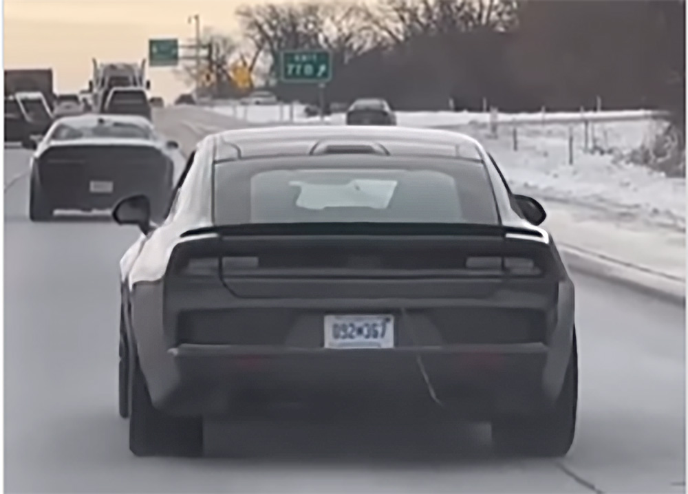 Rear of 2024 Dodge Charger or Challenger pre-production car on highway