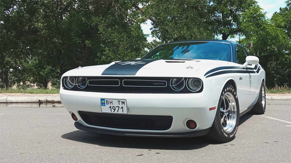 Dodge Challenger built in Ukraine during war with retro styling in white front 3/4